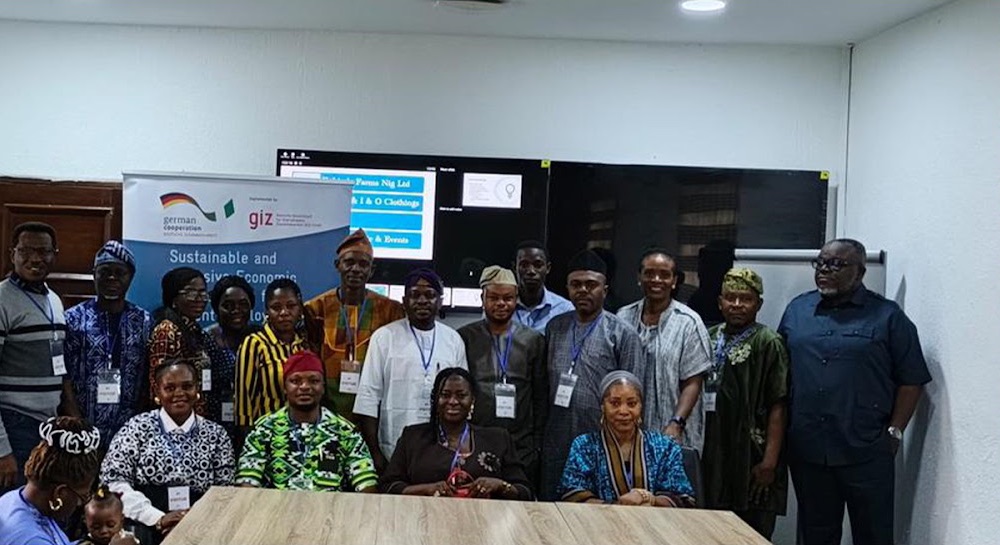 Workshop participants posing together in a conference room